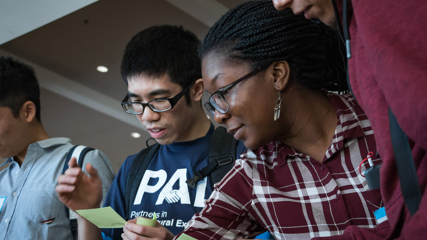 Students having a discussion. One of the students is wearing a PAL t-shirt.