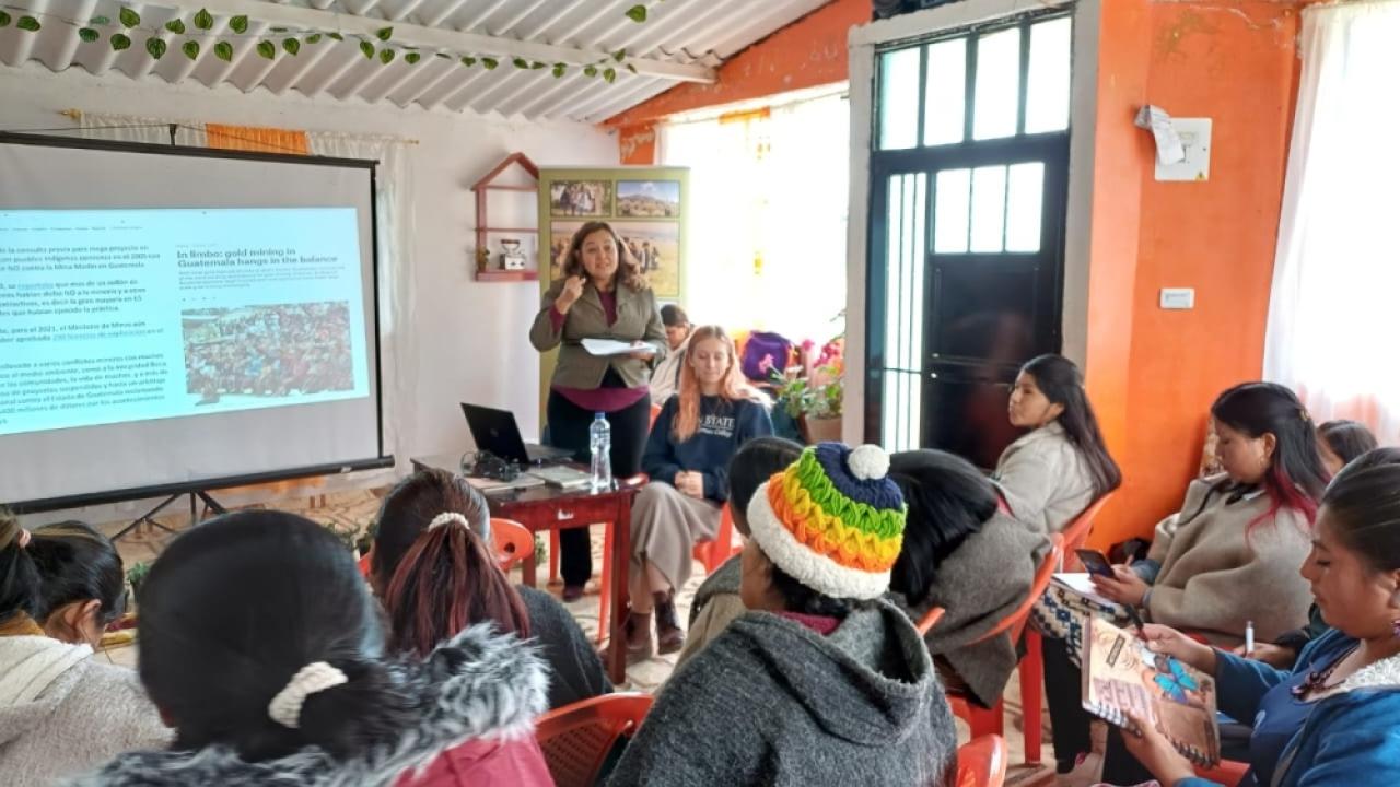 Professor Raquel Aldana and Kari Peterson present a slideshow in front of a group of indigenous rural women in Colombia.